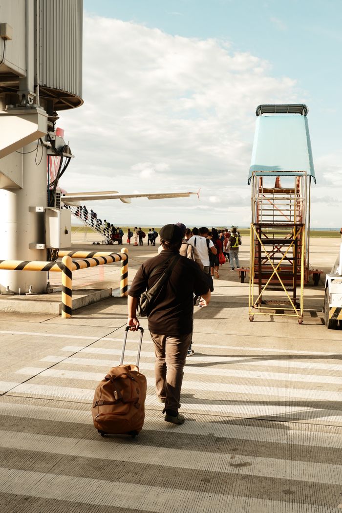 Mastering the First Impression: Your intriguing post title goes here A man with luggage boarding a plane at Laguindingan Airport in the Philippines.